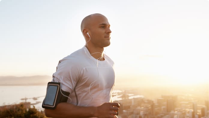 A person exercises outdoors to improve health and wellness. 